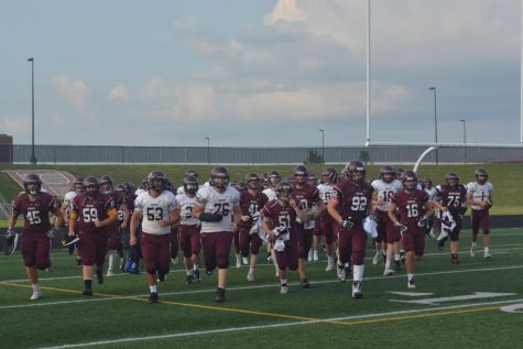The Monarch football team enters the field for the first time in 2018 for the Maroon vs. White scrimmage.