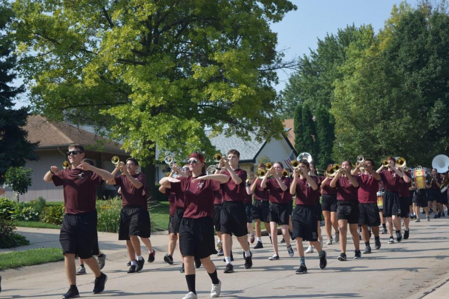 Senior drum majors Jace Armstrong and Sabrina Buls lead the marching band through the neighborhoods.