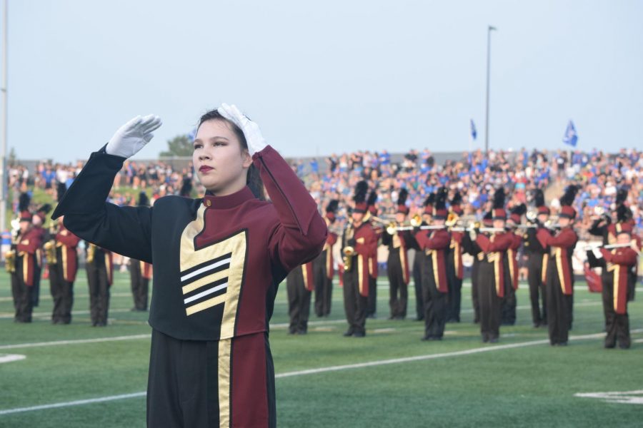 Junior drum major Amy Roach directs the band through pregame.