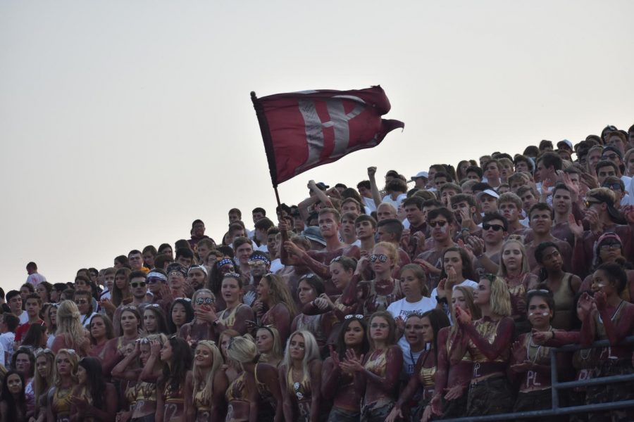 Student Section leader Hayden Bahl waves a Monarch flag at the Papio South game. 