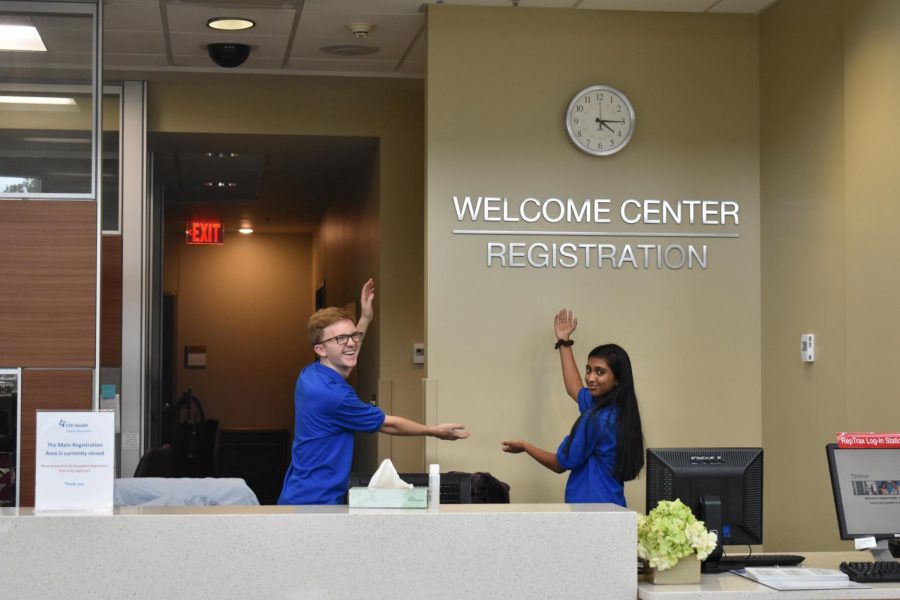 Volunteers Harrison Holloway and Roshu Senthil pose in the Welcome Center at the hospital. They have a blast volunteering there.