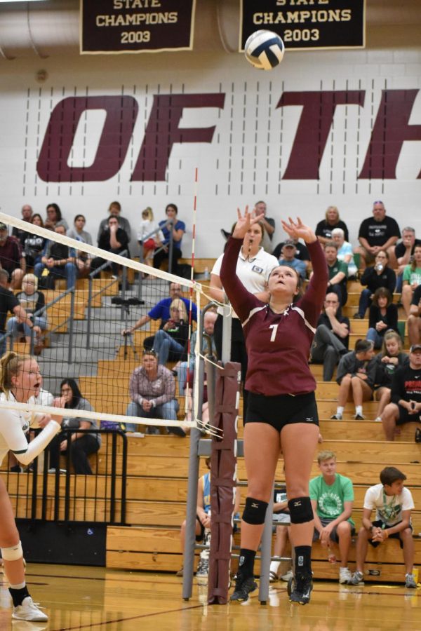 Junior setter Brooklyn Schram sets the ball against Millard West on Aug. 30. The monarchs fell to the Wildcats in four sets.