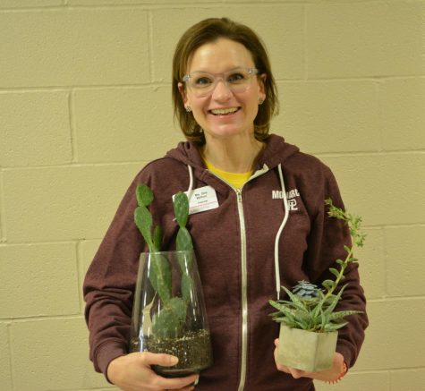 History teacher Mrs. Wilton poses with her two favorite plants.