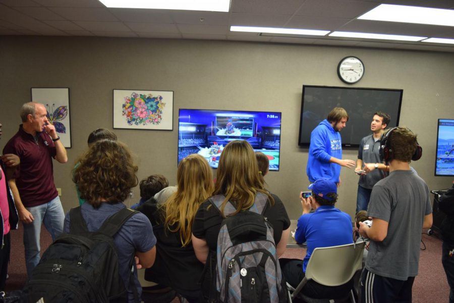 Members of the esports club watch in excitement as two players battle it out in a Super Smash Brothers tournament. The esports club was founded last year following the club creation steps.