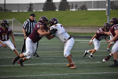 Senior, Wolfe Bonewall Blocks Senior, Matthew Schwartz during the Maroon and White scrimmage.