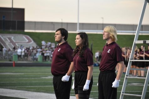 The marching band's three drum majors stand proud before their first full performance. They had a successful halftime, with their entire show on the field.