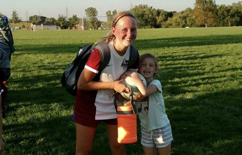 Carlson celebrates with Emily Waldman, the girl she nannies, after a soccer victory.
