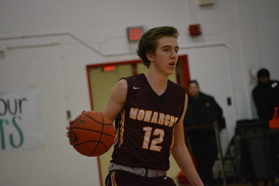 Owen McLaughlin brings the ball down the court in a 2019 game against Westside. The Monarch boys will return this year to play them again.