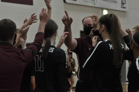 The varsity volleyball team breaks it down, wearing their masks for safety, in their game against Bellevue West.