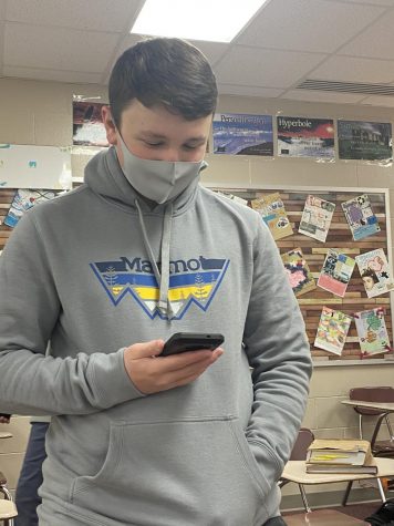Junior Will Adair uses his phone often before class.