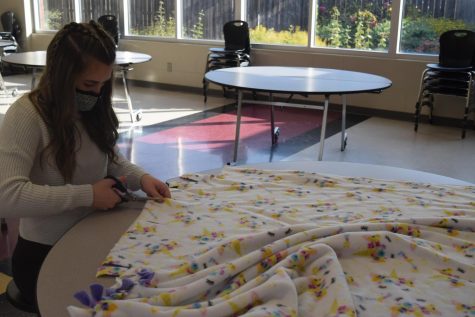 Sophomore Jordan Bechner makes blankets for Leo Club. The club gathered to create blankets for the Linus Project this past Saturday.