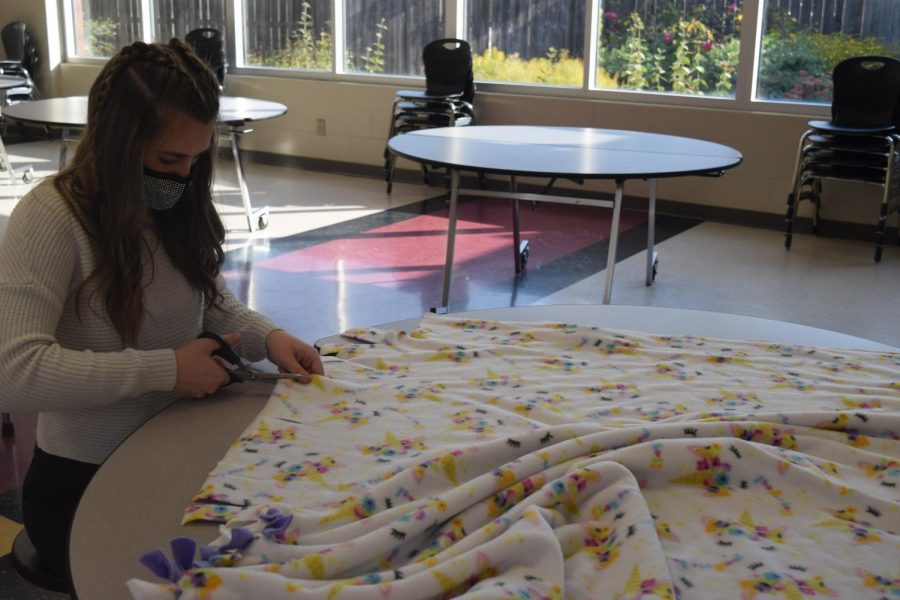 Sophomore Jordan Bechner makes blankets for Leo Club. The club gathered to create blankets for the Linus Project this past Saturday. 