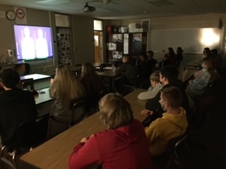 Student athletes gather together to hear a message through a Zoom meeting for FCAs Night of Champions event. 