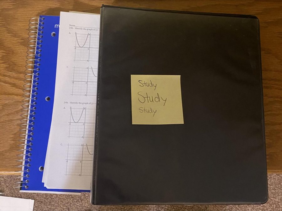 Pictured here is my notebook full of notes, my algebra final reviews and a binder with more notes.