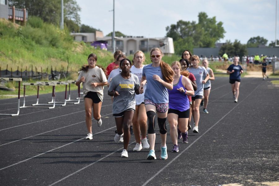 The girls cross country team during their timed mile at practice.
