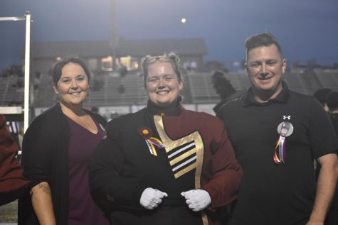 Senior drum major Kiera Miller poses with her parents during her senior night. The band celebrated on September 30.