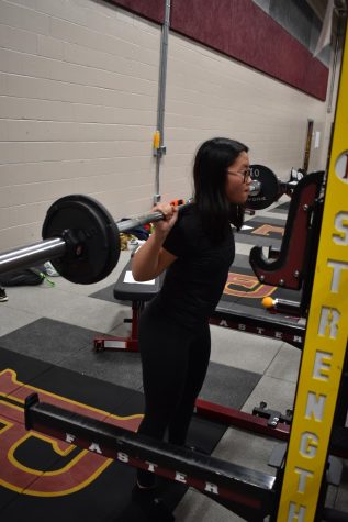 PLHS sophomore Alexis Hoang takes practices her squat 