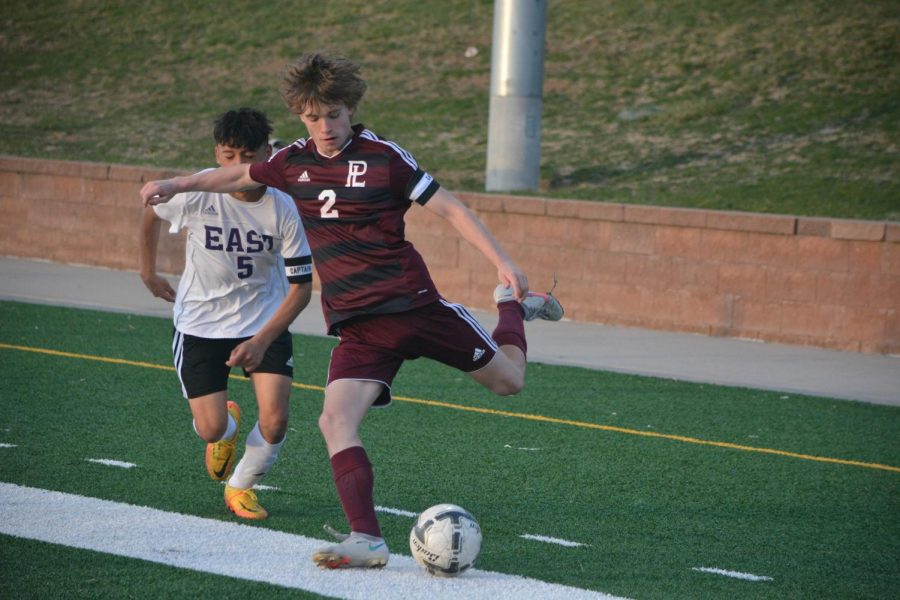 Senior Keegan Hylok lines up to cross the ball late in the first half.