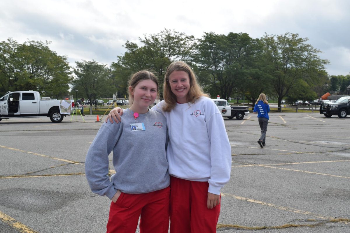 Junior Evie Frisch and Adeline Bigelow poses for a picture during Vehicle Day.