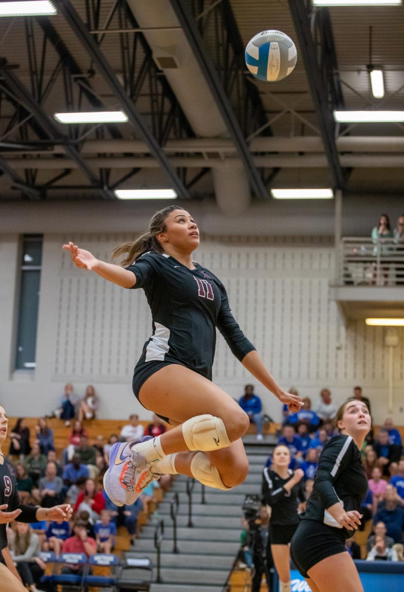 Senior Middle Blocker Mia Tvrdy attempts to keep the ball up during the Tuesday night game against the Titans.