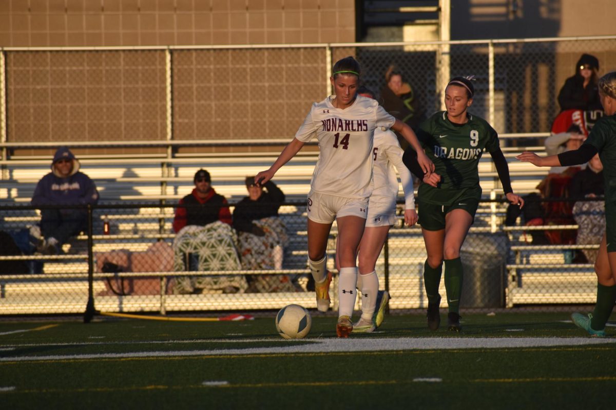 Junior Izzy Ashby passes the ball to a teammate, setting her up to score a goal