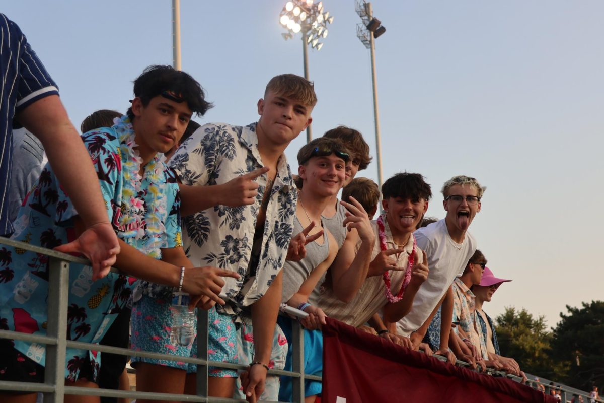 The student section leaders and others get hyped at a football game.