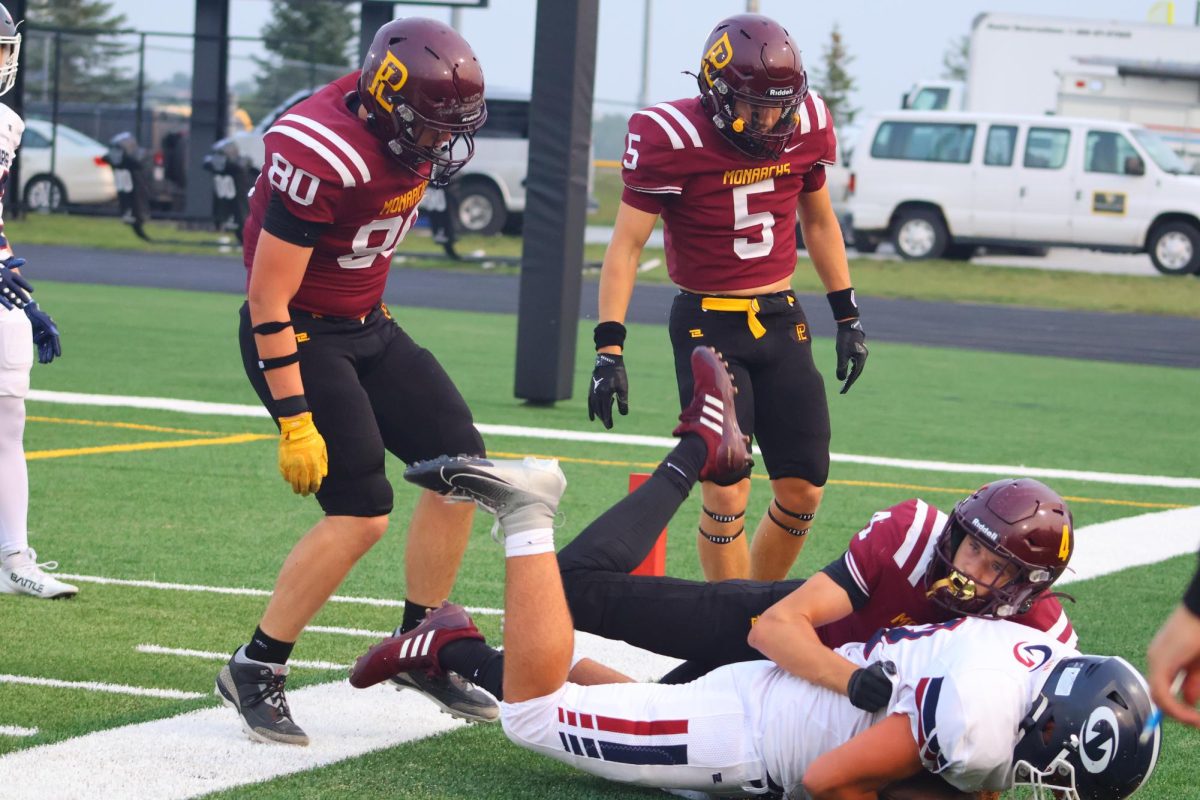 Junior Corner Coen Hoevet stands over Lincoln Northstar player on an assisted tackle.