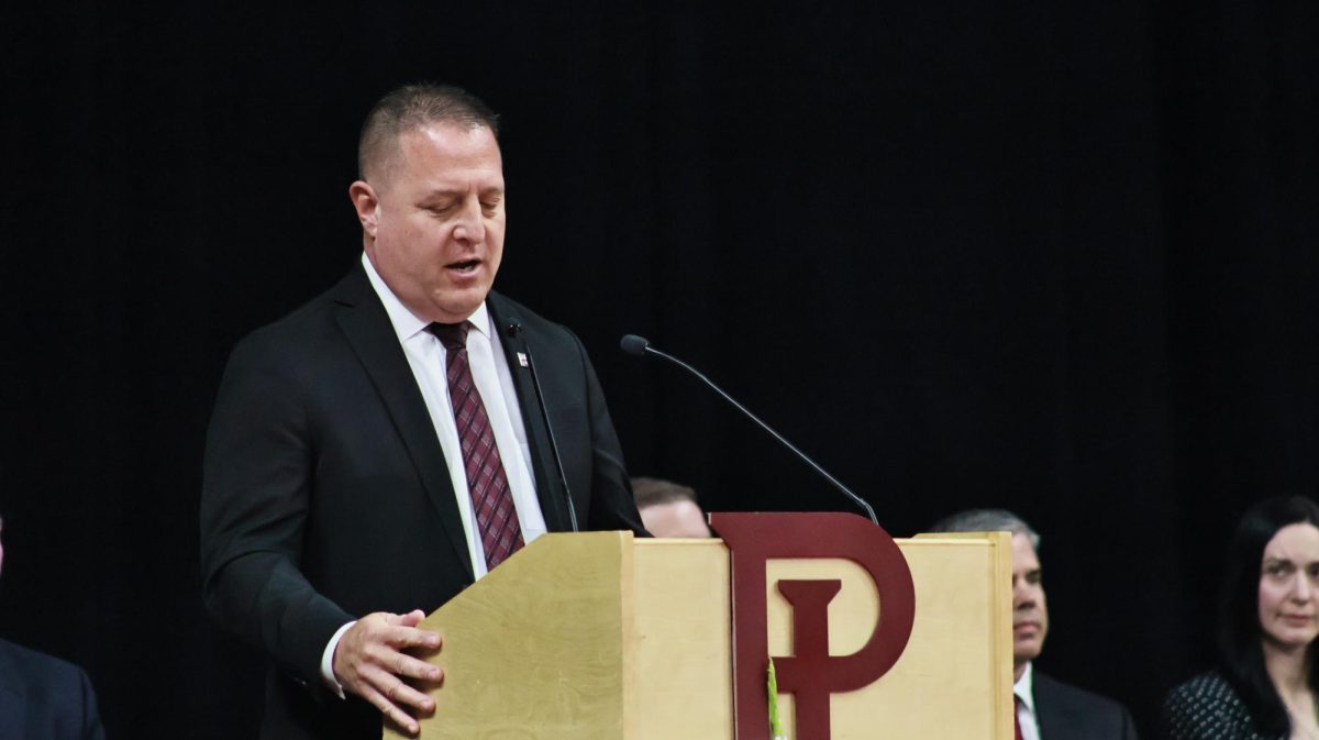 Principal Jason Ryan gives the speech  to begin the graduation ceremony. 