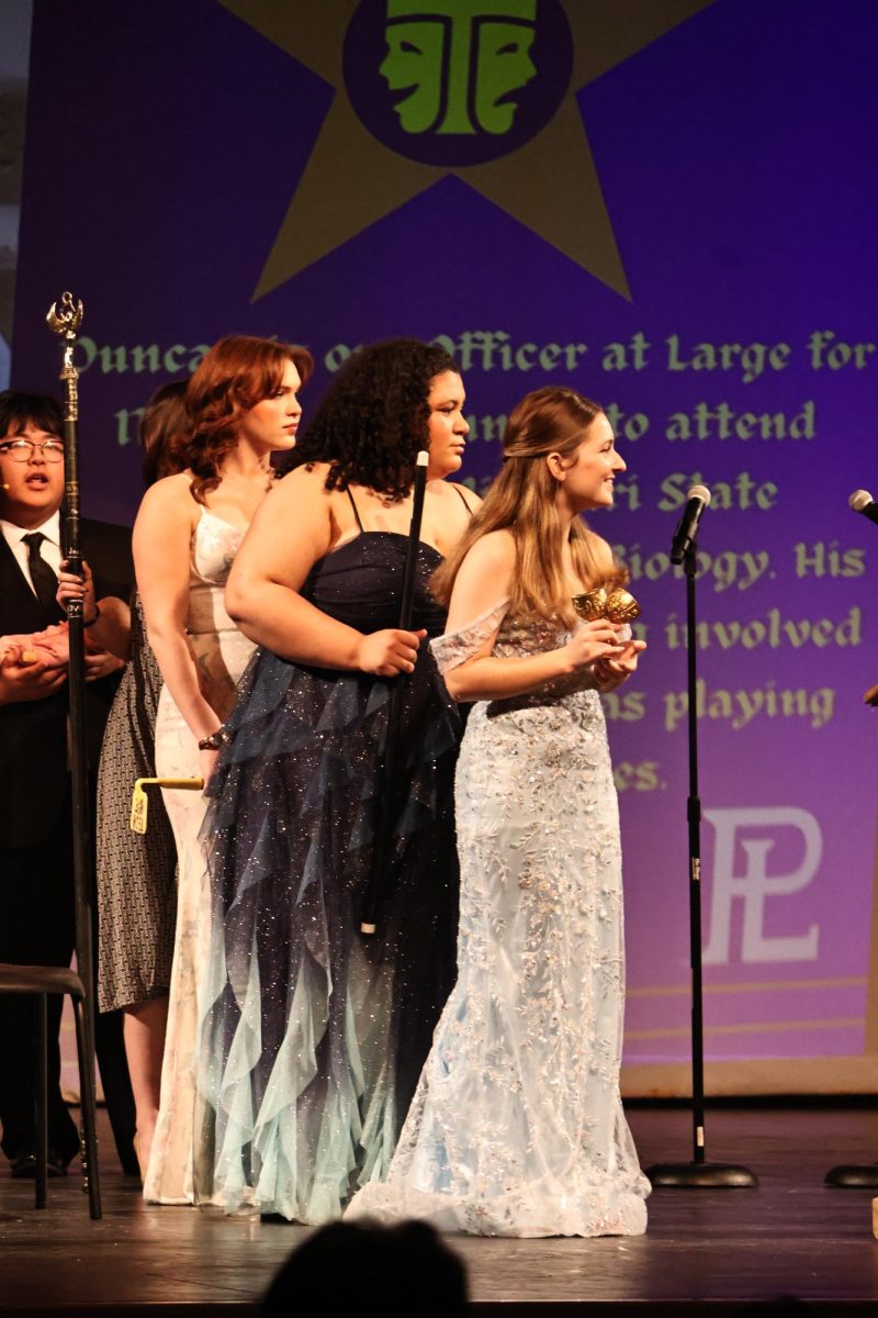 Seniors Audrey Campbell, Amari Zach, and Caroline Williams wait expectantly for passdowns at PLHS International Thespian Society Awards. Passdowns are when a senior awards an underclassmen a type of theatrical superlative.