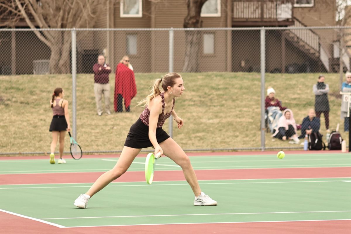 Senior Maia Waszak returns a serve in her match against Papillion South and Bellevue East. The team competed in the triangular with multiple great battles.