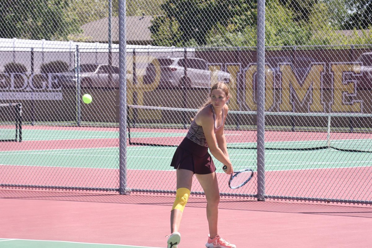 Junior Aurelia Grams tracks the ball as she prepares to hit a backhand .