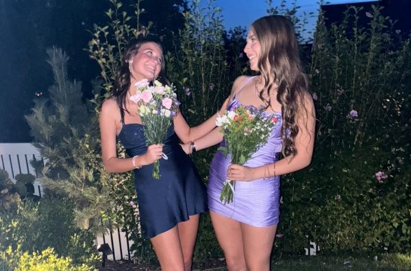 Emily Ballou and Tinley Tanton pose for a picture, dressed up for their freshman year Homecoming. 